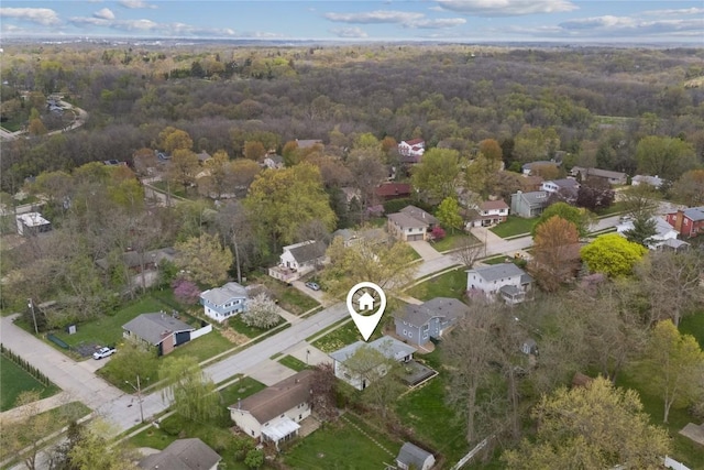 birds eye view of property featuring a view of trees and a residential view