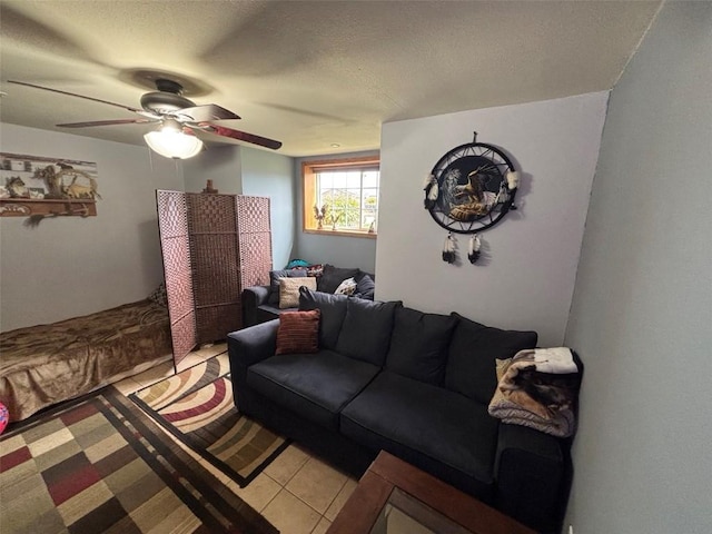 living area with a ceiling fan and a textured ceiling