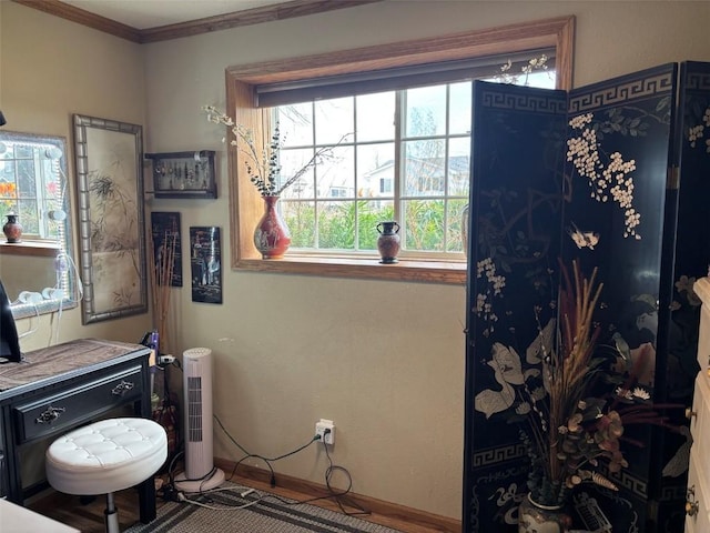 bathroom featuring crown molding and baseboards