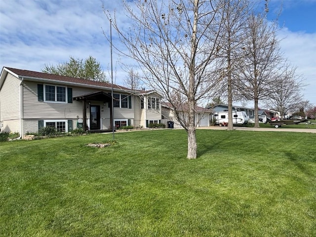 bi-level home featuring driveway and a front lawn