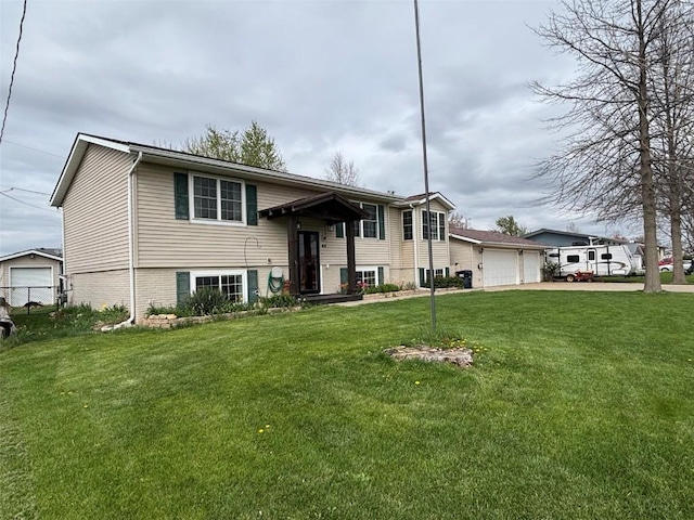 split foyer home with a garage, driveway, and a front lawn
