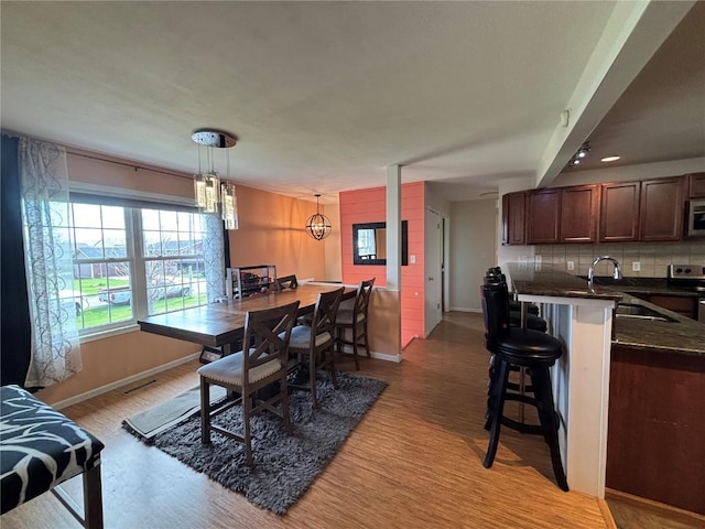 dining room with light wood-style floors and baseboards