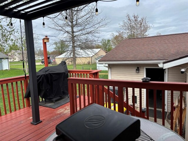 deck featuring a yard and a pergola