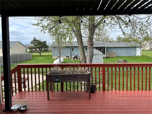 wooden terrace featuring a lawn