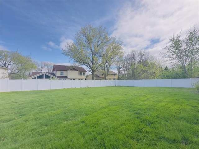 view of yard with fence and a residential view