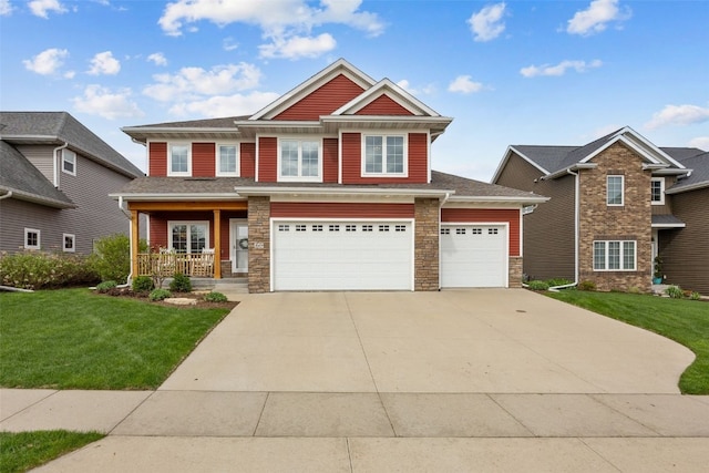 craftsman house featuring an attached garage, stone siding, a front yard, concrete driveway, and a porch