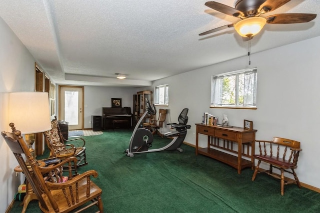 sitting room with carpet floors, a ceiling fan, a textured ceiling, and baseboards