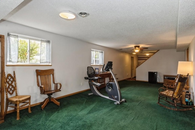 workout room with carpet floors, visible vents, baseboards, ceiling fan, and a textured ceiling