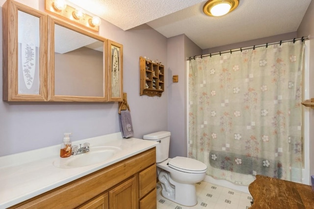 bathroom with vanity, toilet, and a textured ceiling