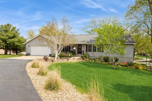 ranch-style home with a garage, driveway, a shingled roof, and a front lawn