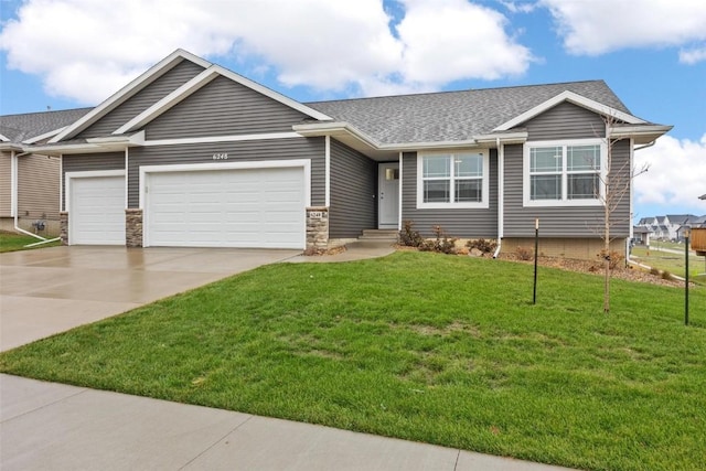view of front of home with a garage, concrete driveway, roof with shingles, and a front yard