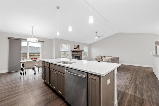 kitchen featuring ceiling fan, dishwasher, a sink, light countertops, and dark wood-type flooring