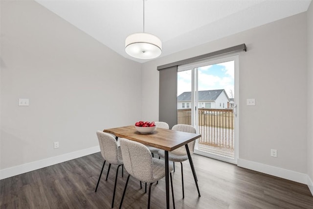 dining area with baseboards and wood finished floors