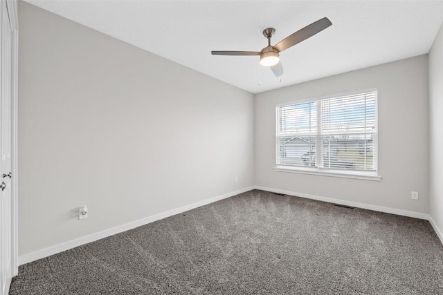 carpeted spare room with a ceiling fan, baseboards, and visible vents