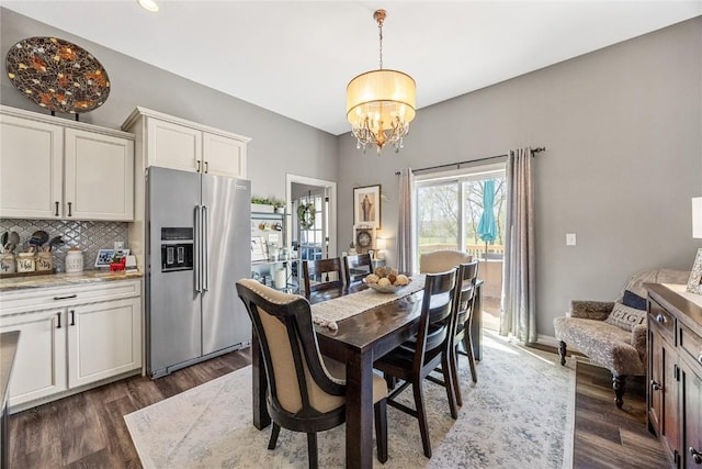 208 Willowood Dr, Hiawatha, IA 52233 - dining space featuring a chandelier and dark wood-type flooring