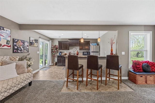 208 Willowood Dr, Hiawatha, IA 52233 - dining space featuring light colored carpet and baseboards