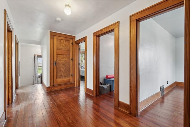 foyer entrance with baseboards, plenty of natural light, and dark wood-type flooring