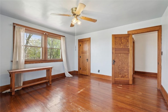 bedroom with baseboards, ceiling fan, and wood finished floors