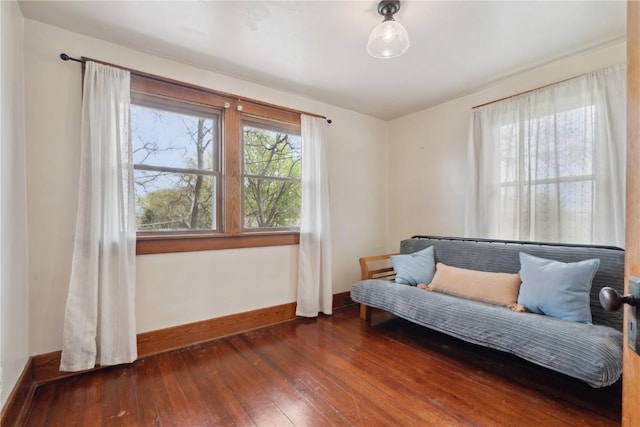 sitting room with baseboards and hardwood / wood-style flooring