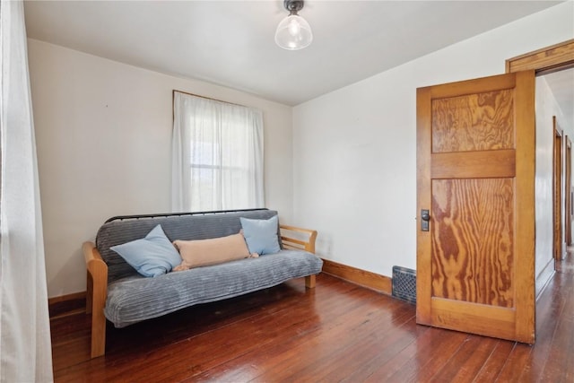 sitting room featuring baseboards and hardwood / wood-style floors