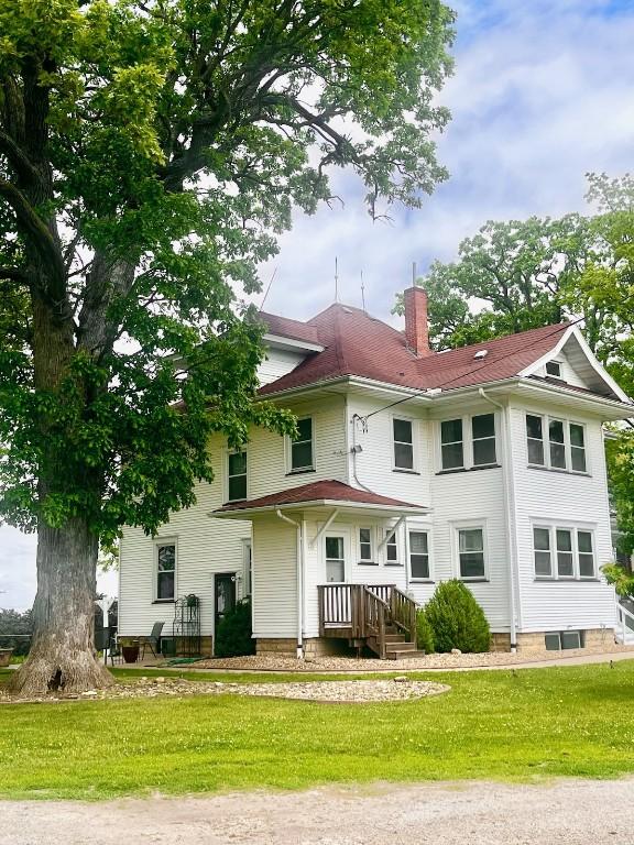527 Swisher View Dr SW, Swisher, IA 52338 - rear view of house with a chimney and a lawn