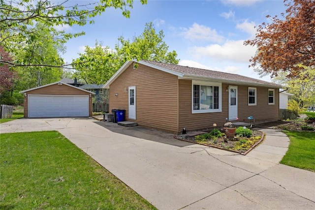 exterior space with a detached garage, an outdoor structure, and a front yard