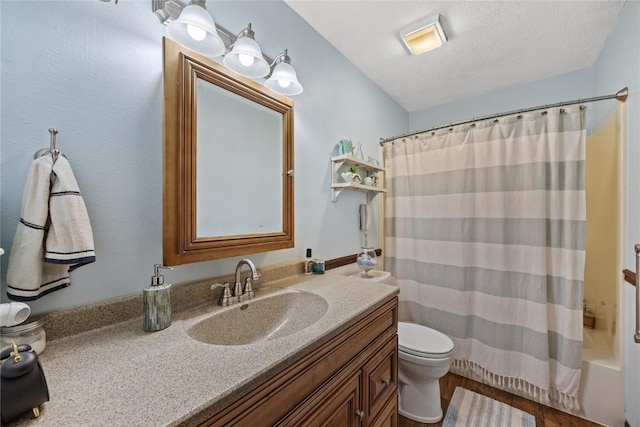 bathroom with vanity, wood finished floors, and toilet
