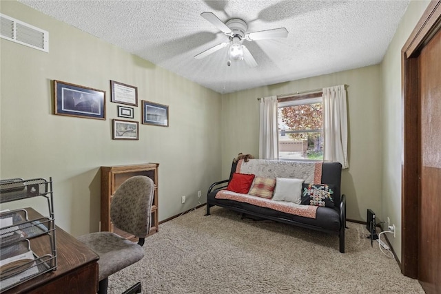 office area with ceiling fan, carpet flooring, a textured ceiling, and visible vents