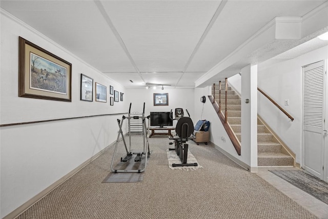 exercise room with carpet floors and baseboards