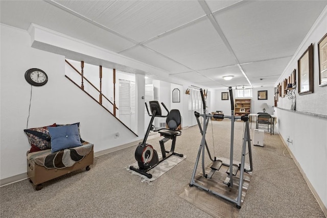 exercise room featuring baseboards and carpet