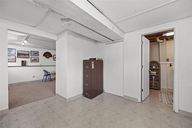finished basement featuring tile patterned floors and baseboards