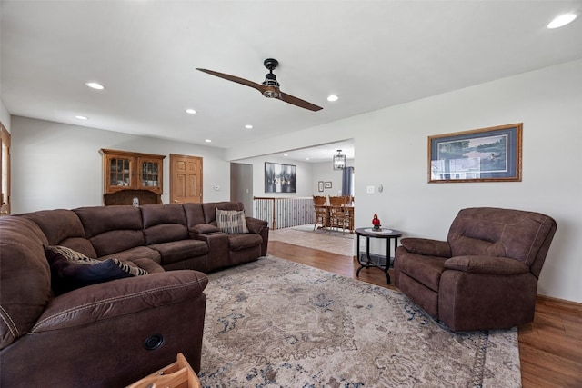 living area with a ceiling fan, recessed lighting, and wood finished floors