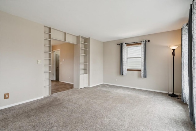 interior space with carpet floors and baseboards