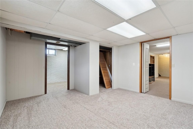 basement with carpet floors and a drop ceiling