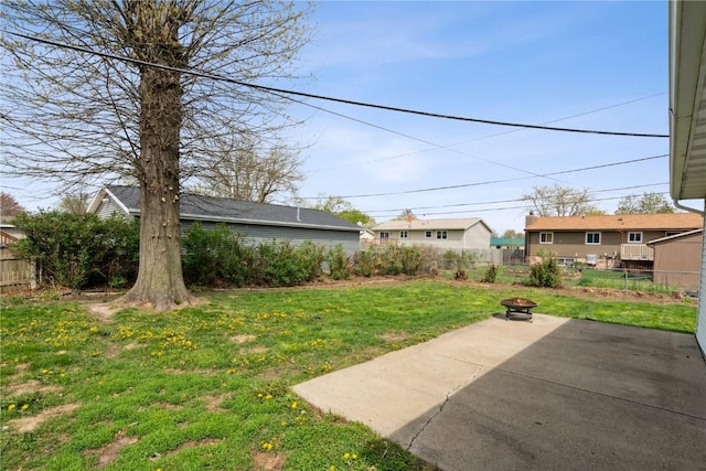 view of yard featuring a patio, fence, and an outdoor fire pit