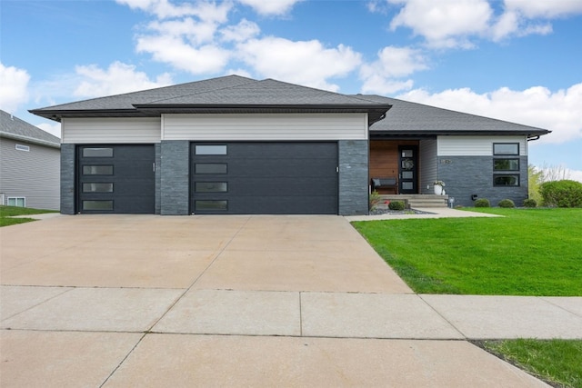 prairie-style home with a garage, driveway, and a front yard