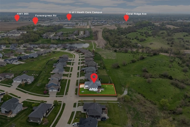 drone / aerial view featuring a water view and a residential view