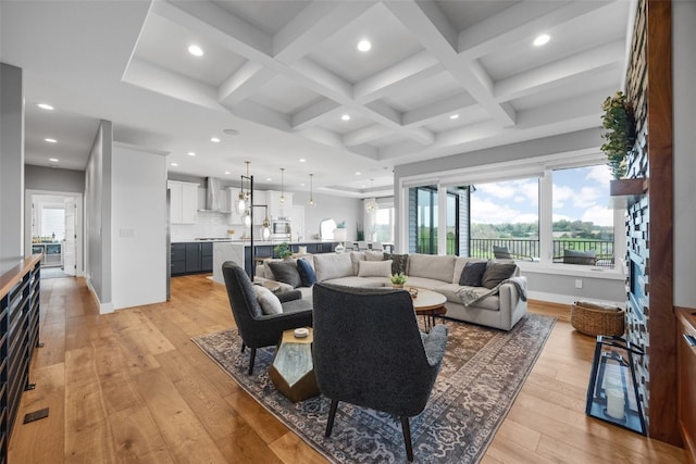living room featuring recessed lighting, plenty of natural light, and light wood-type flooring