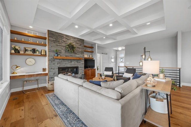 living area with visible vents, light wood-style flooring, coffered ceiling, and recessed lighting