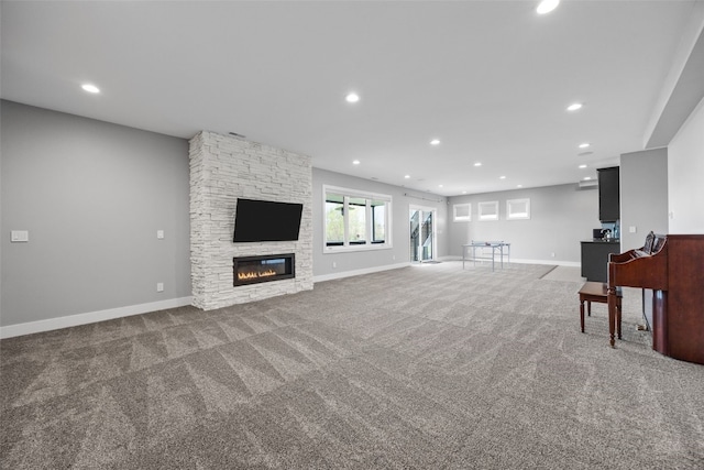 unfurnished living room featuring recessed lighting, carpet flooring, and a fireplace