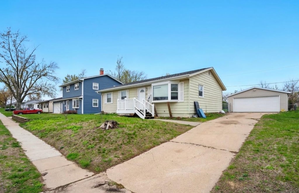 view of front of property with an outdoor structure, a garage, and a front yard
