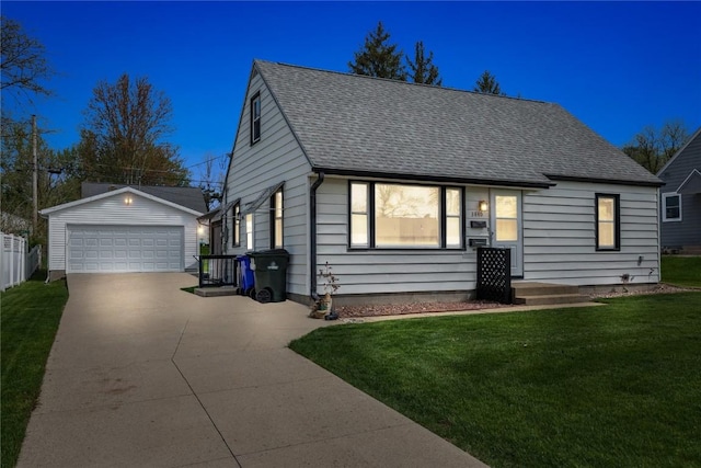 cape cod house with a detached garage, an outdoor structure, a shingled roof, and a front yard