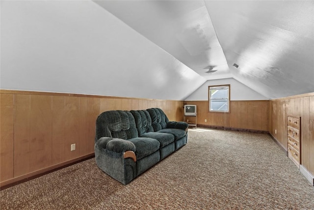bonus room with wood walls, lofted ceiling, and carpet flooring
