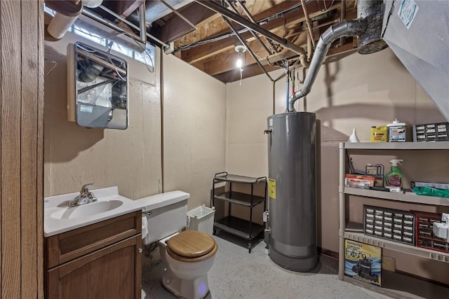 bathroom featuring toilet, water heater, and vanity
