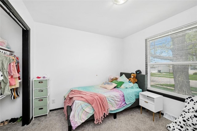 bedroom with carpet flooring, baseboards, and multiple windows