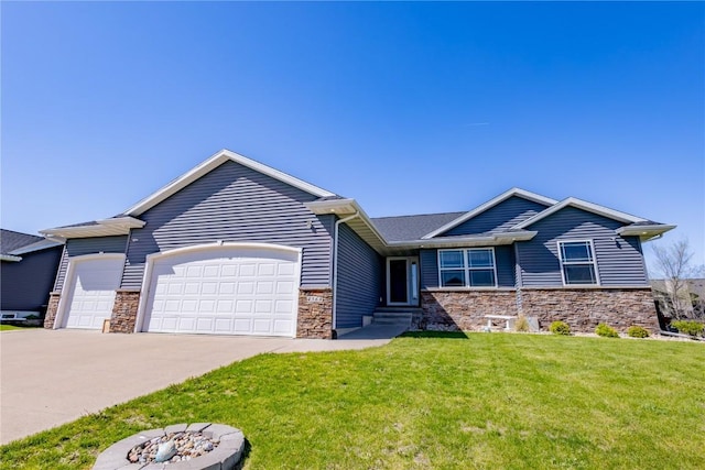 craftsman inspired home featuring a garage, a front lawn, a fire pit, stone siding, and driveway