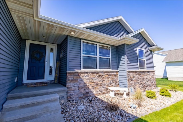 property entrance featuring stone siding