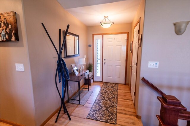 entrance foyer featuring baseboards and light wood-style floors