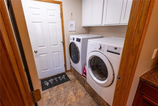 laundry area with stone finish flooring, cabinet space, and independent washer and dryer