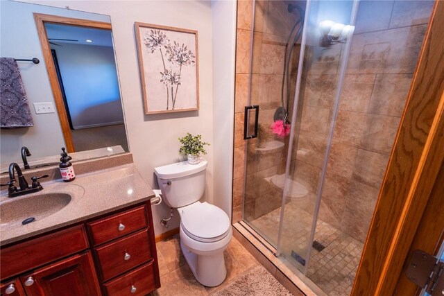 full bath featuring vanity, tile patterned floors, a stall shower, and toilet
